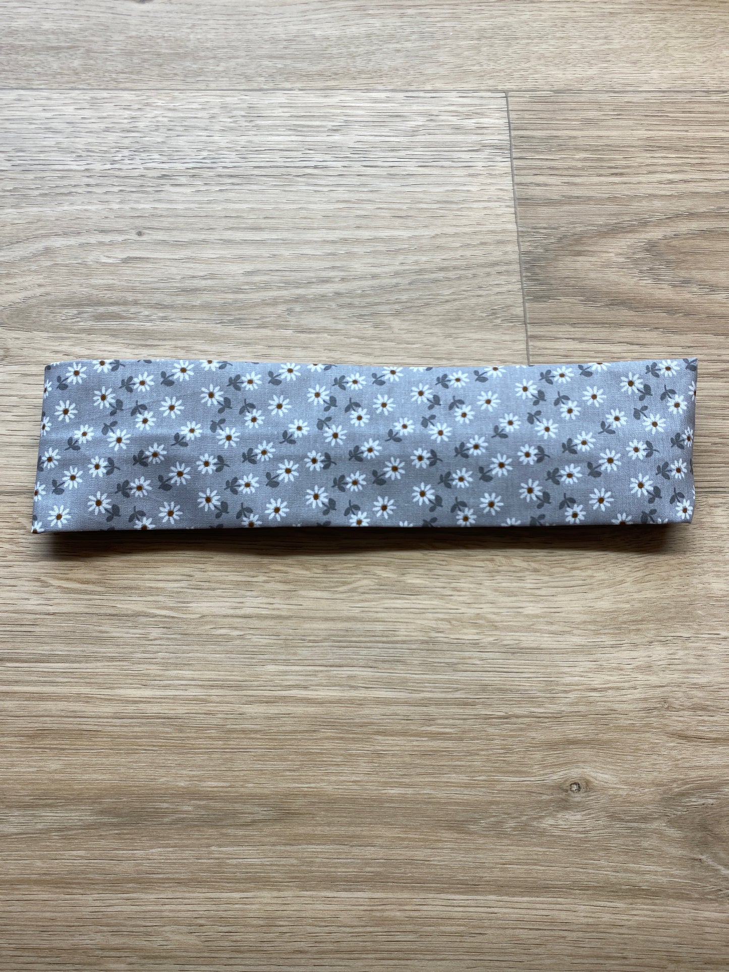 Grått hårbånd med hvite blomster